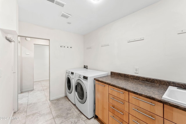 7385 E Pleasant Run, Scottsdale, AZ 85258 - laundry room with independent washer and dryer, light tile patterned floors, and cabinet space