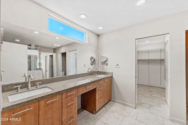7385 E Pleasant Run, Scottsdale, AZ 85258 - bathroom with double vanity, tile patterned floors, recessed lighting, and a walk in closet
