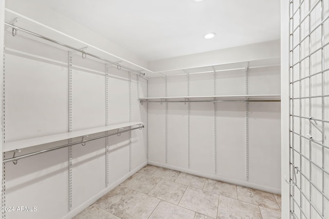 7385 E Pleasant Run, Scottsdale, AZ 85258 - walk in closet with light tile patterned floors