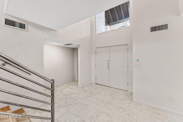 7385 E Pleasant Run, Scottsdale, AZ 85258 - entryway with a towering ceiling, stairs, and light tile patterned floors
