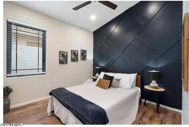 bedroom with ceiling fan and hardwood / wood-style flooring