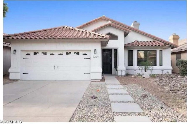 mediterranean / spanish home featuring a garage