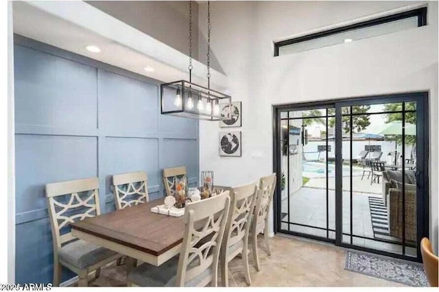 dining space featuring a towering ceiling