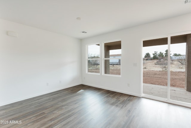 spare room with dark hardwood / wood-style flooring