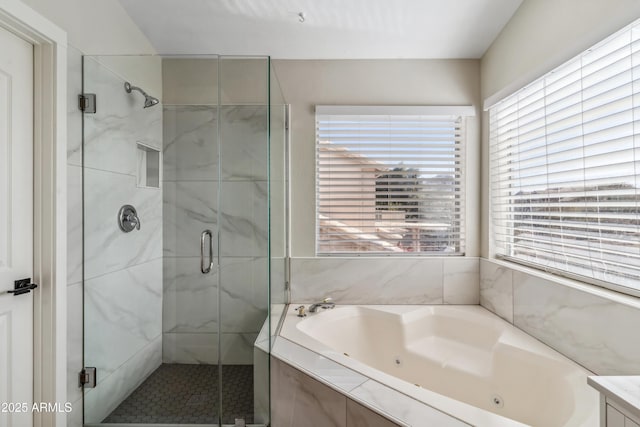 bathroom featuring independent shower and bath