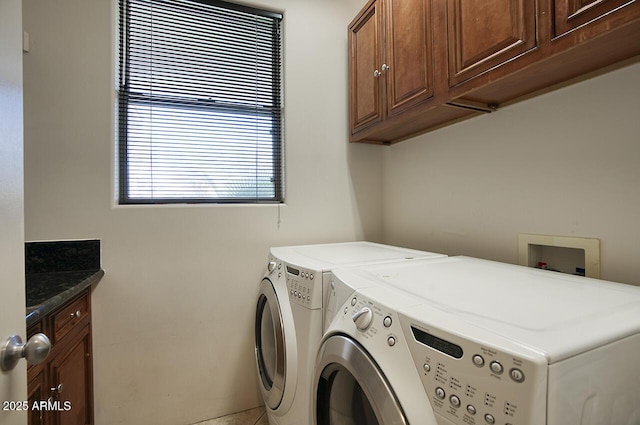 laundry area with cabinet space and separate washer and dryer