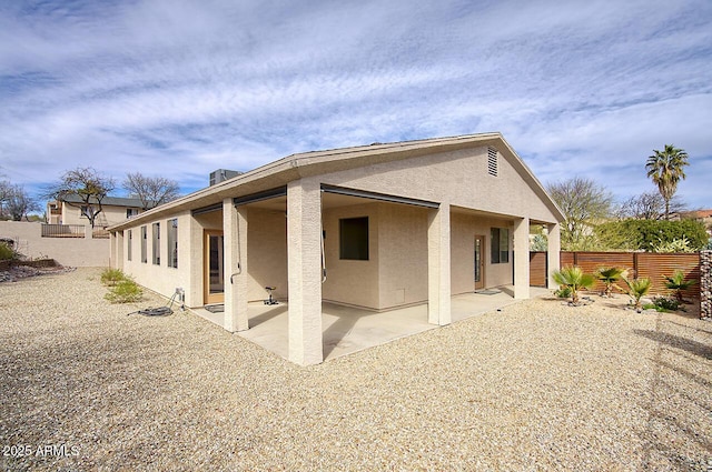 exterior space featuring a fenced backyard, a patio, and stucco siding