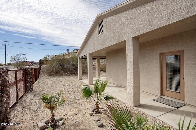 view of yard featuring fence and a patio