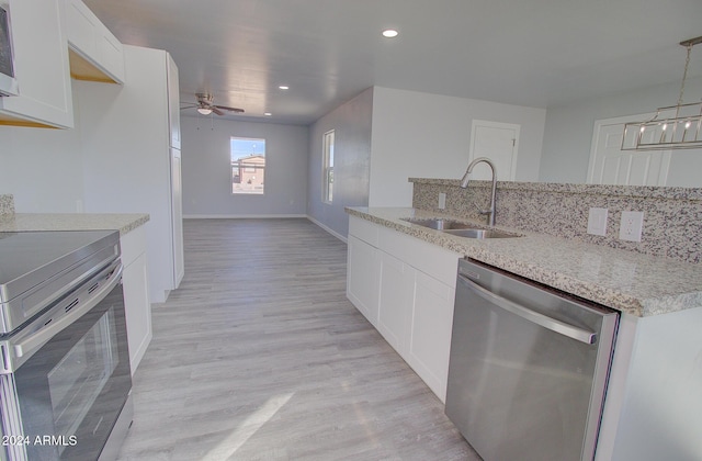 kitchen featuring a sink, appliances with stainless steel finishes, white cabinets, light wood finished floors, and ceiling fan