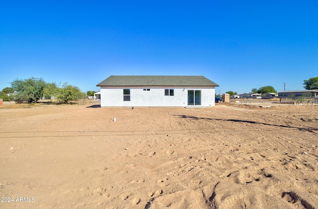 back of property featuring stucco siding