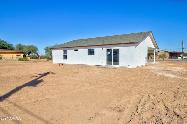 back of house with stucco siding