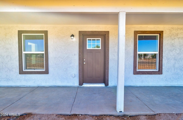 property entrance with stucco siding