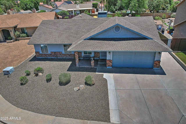 927 N Somerset Cir, Mesa, AZ 85205 - view of front of house with a shingled roof, driveway, an attached garage, stucco siding, and brick siding