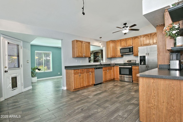 927 N Somerset Cir, Mesa, AZ 85205 - kitchen with stainless steel appliances, dark countertops, ceiling fan, dark wood-type flooring, and brown cabinetry