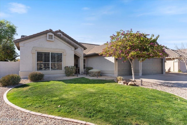 view of front of house with driveway, a front yard, an attached garage, and stucco siding