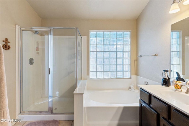 bathroom with vanity, a shower stall, and a bath