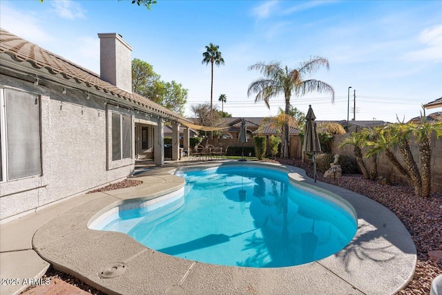 view of swimming pool with a patio area and a fenced backyard