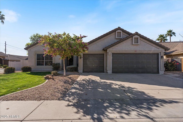 view of front of house with a garage, driveway, a front lawn, and stucco siding