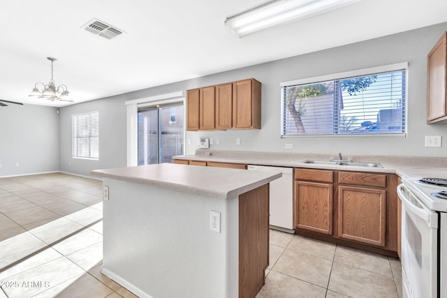 kitchen featuring white appliances, a chandelier, light tile patterned flooring, and sink