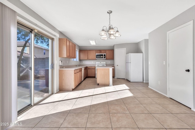 kitchen featuring a center island, white appliances, light tile patterned flooring, pendant lighting, and a notable chandelier