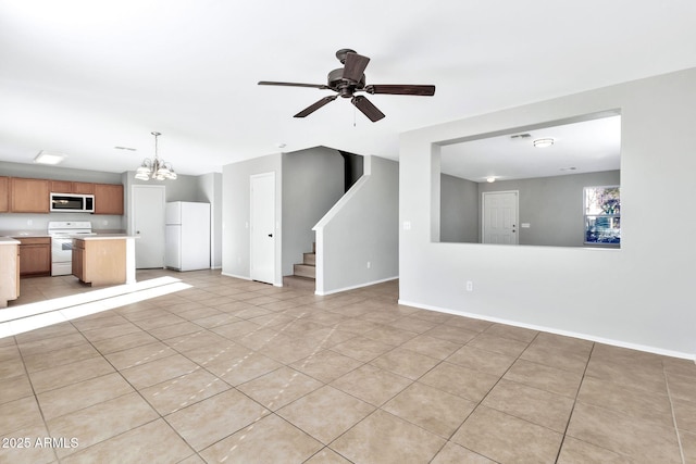 unfurnished living room featuring ceiling fan with notable chandelier and light tile patterned floors