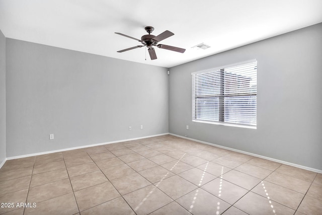 spare room featuring ceiling fan and light tile patterned floors