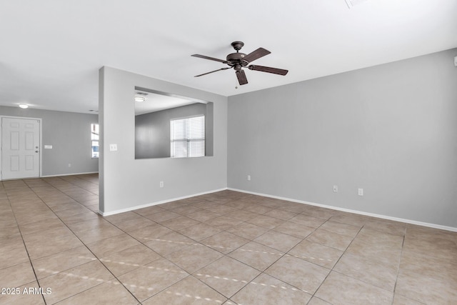 empty room featuring ceiling fan and light tile patterned floors