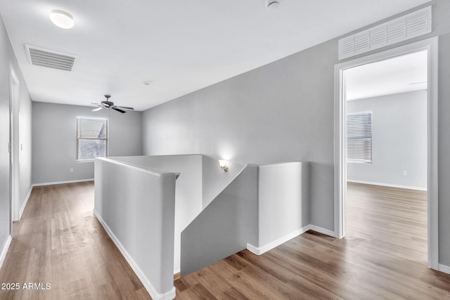 hall with hardwood / wood-style floors