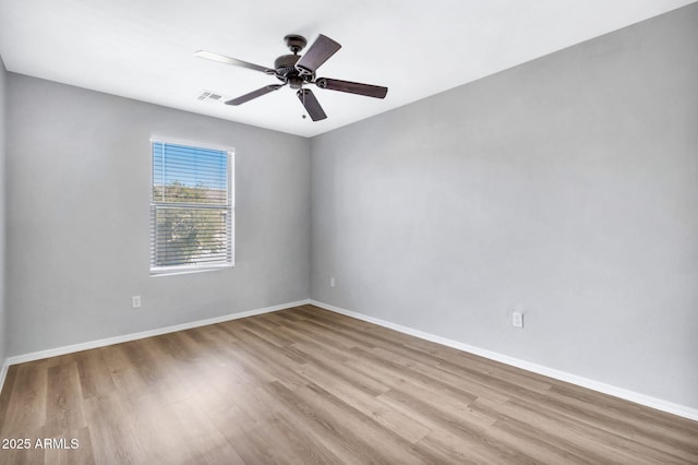 spare room with light hardwood / wood-style floors and ceiling fan