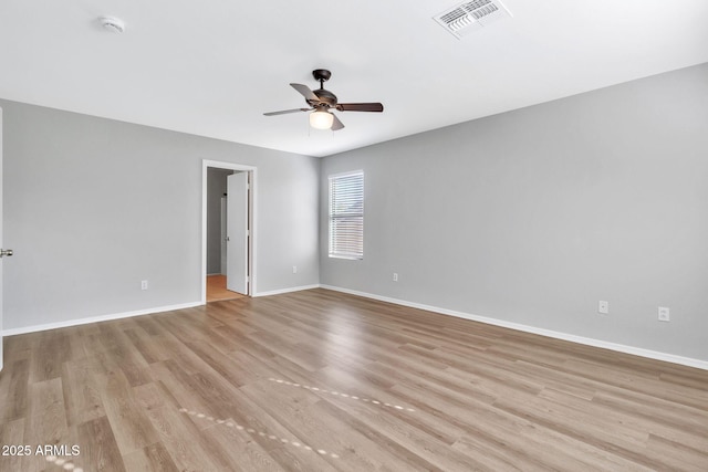 empty room with ceiling fan and light hardwood / wood-style flooring