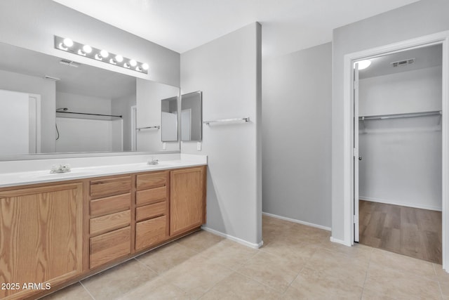 bathroom with tile patterned flooring and vanity