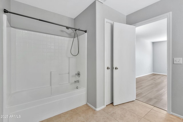 bathroom with tile patterned floors and bathtub / shower combination