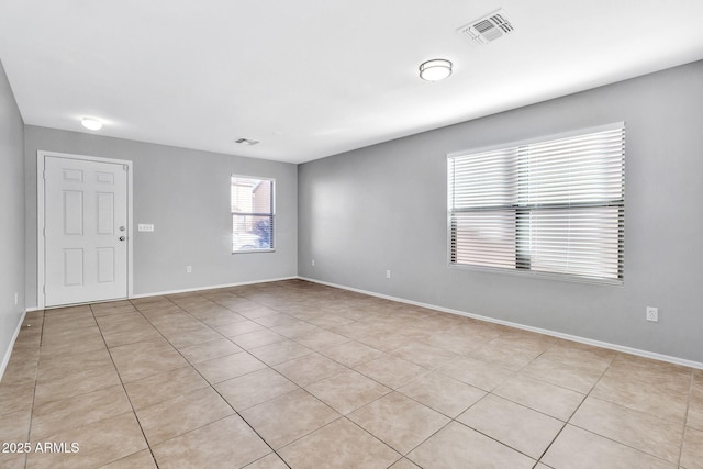 empty room with light tile patterned floors