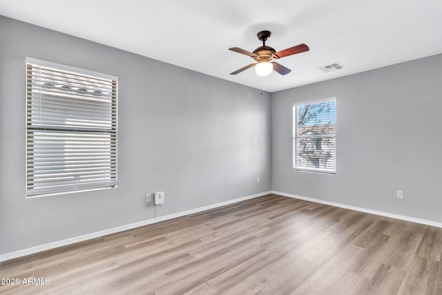 spare room featuring ceiling fan and light hardwood / wood-style floors