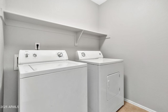 washroom featuring washer and dryer and light tile patterned flooring