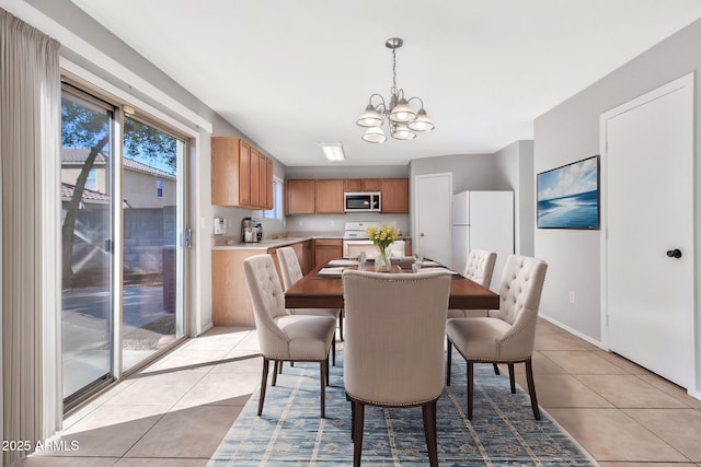 dining room featuring light tile patterned flooring and an inviting chandelier