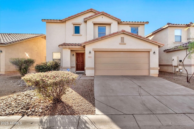 mediterranean / spanish-style home with a garage