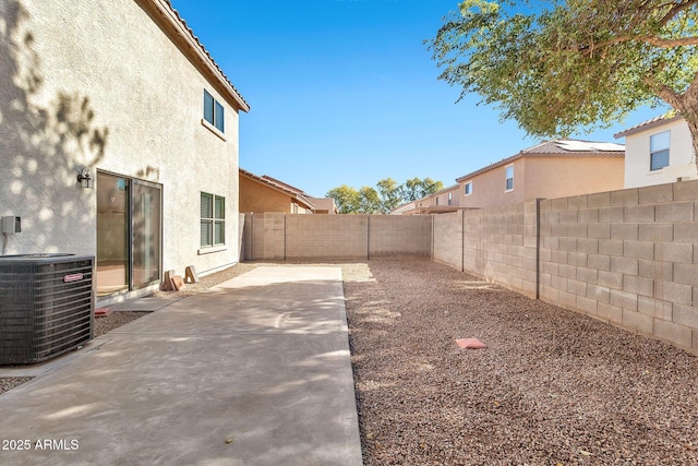 view of yard featuring central air condition unit and a patio area