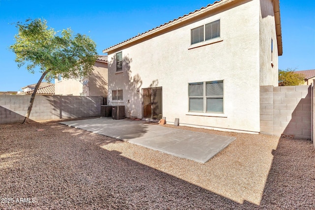 back of property with a patio area and central AC