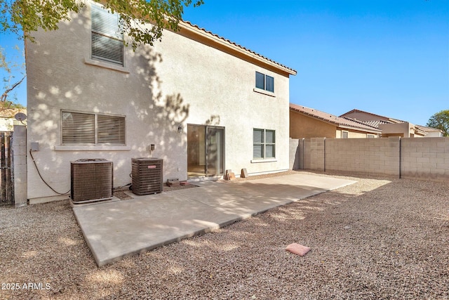 back of property featuring cooling unit and a patio