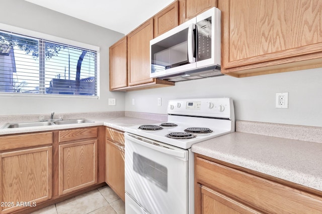 kitchen with white range with electric stovetop, light tile patterned flooring, and sink