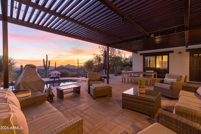 patio terrace at dusk with a pergola and an outdoor hangout area