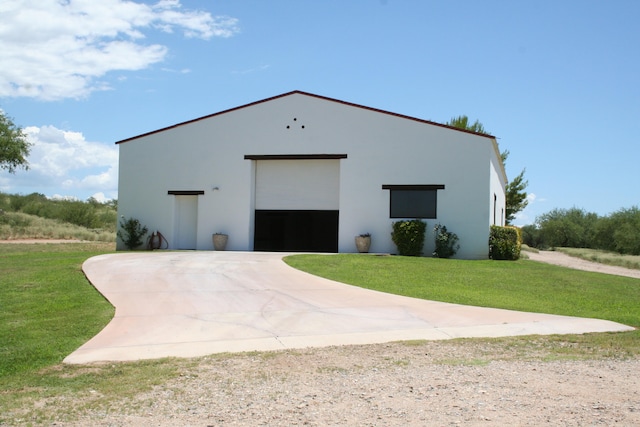 view of outdoor structure featuring a yard and a garage