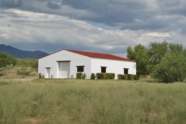 view of outbuilding featuring a mountain view