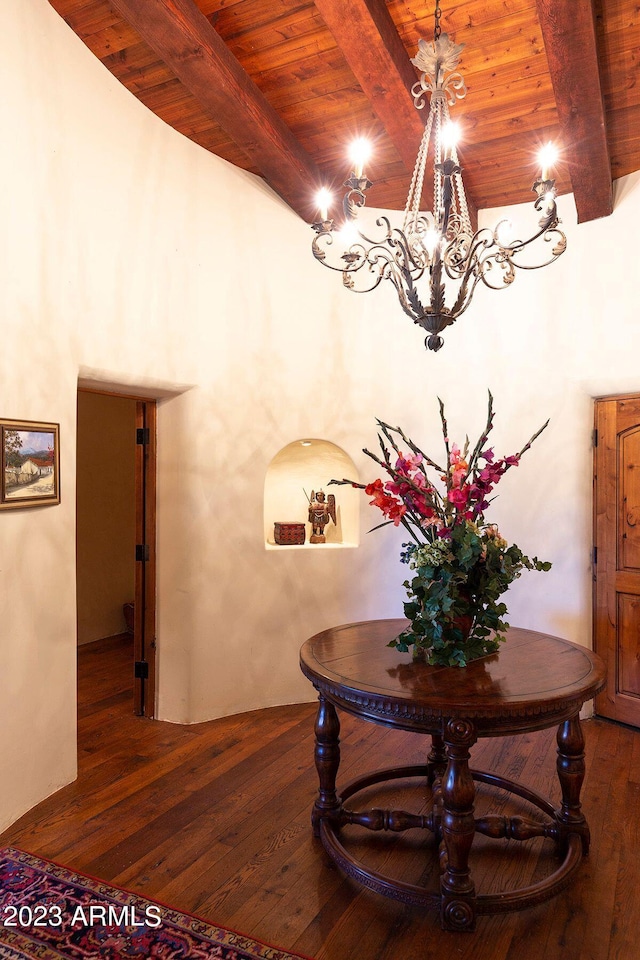 interior space with beam ceiling, wood ceiling, dark wood-type flooring, and a notable chandelier