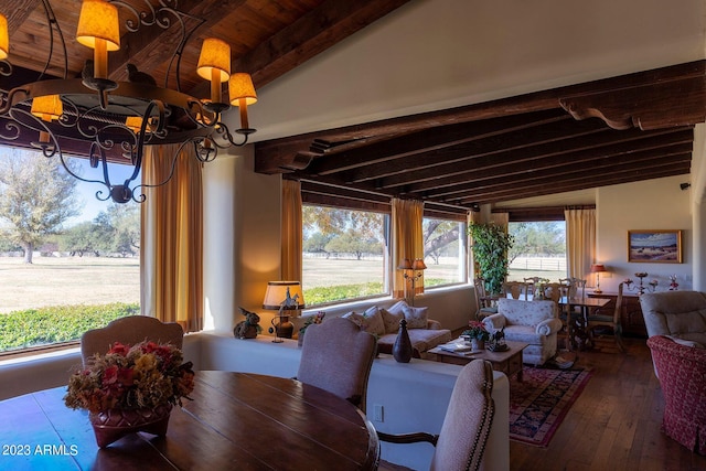 dining area with lofted ceiling with beams and hardwood / wood-style flooring