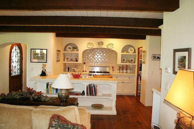 dining area with beam ceiling, wood ceiling, dark wood-type flooring, and sink