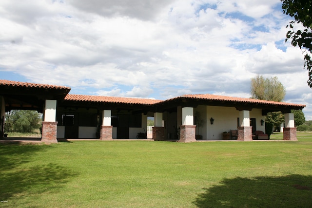 rear view of property with a lawn