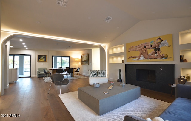 living room with lofted ceiling and hardwood / wood-style flooring