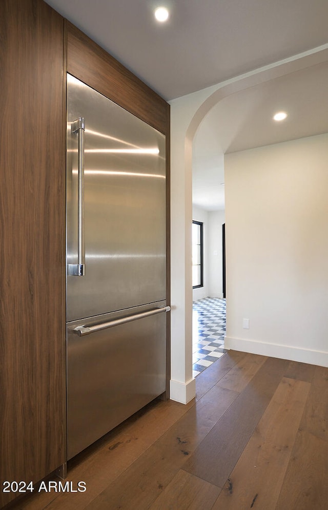 details featuring stainless steel built in fridge and hardwood / wood-style floors